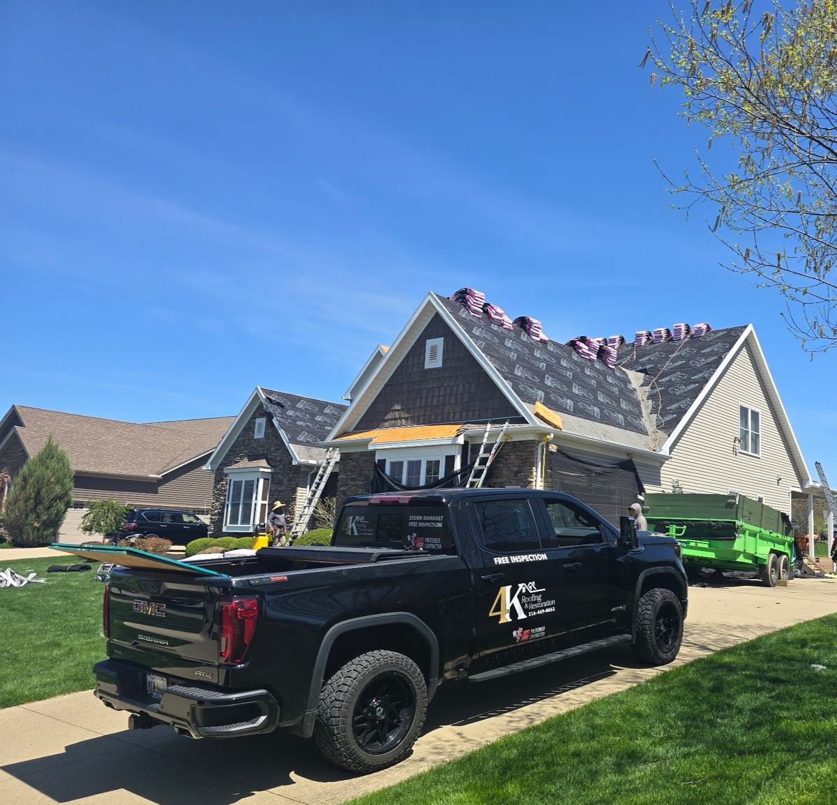 4K Roofing & Restoration truck at a completed roof replacement in Northeast Ohio