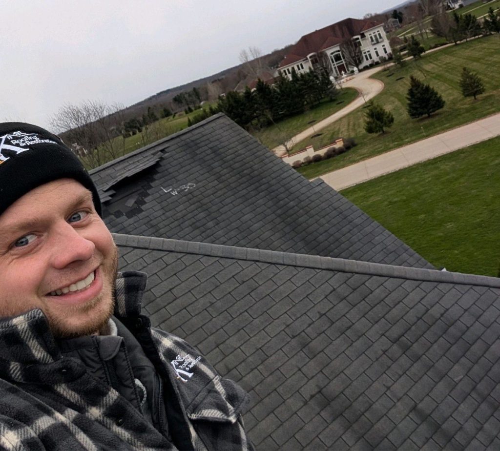 4K Roofing team member on a newly inspected asphalt shingle roof in Northeast Ohio