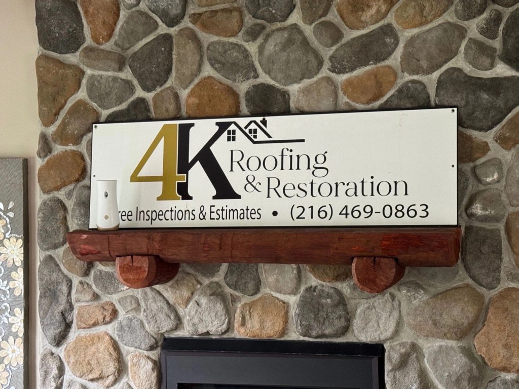 4K Roofing and Restoration sign offering free roof inspections and estimates, phone 216.469.0863