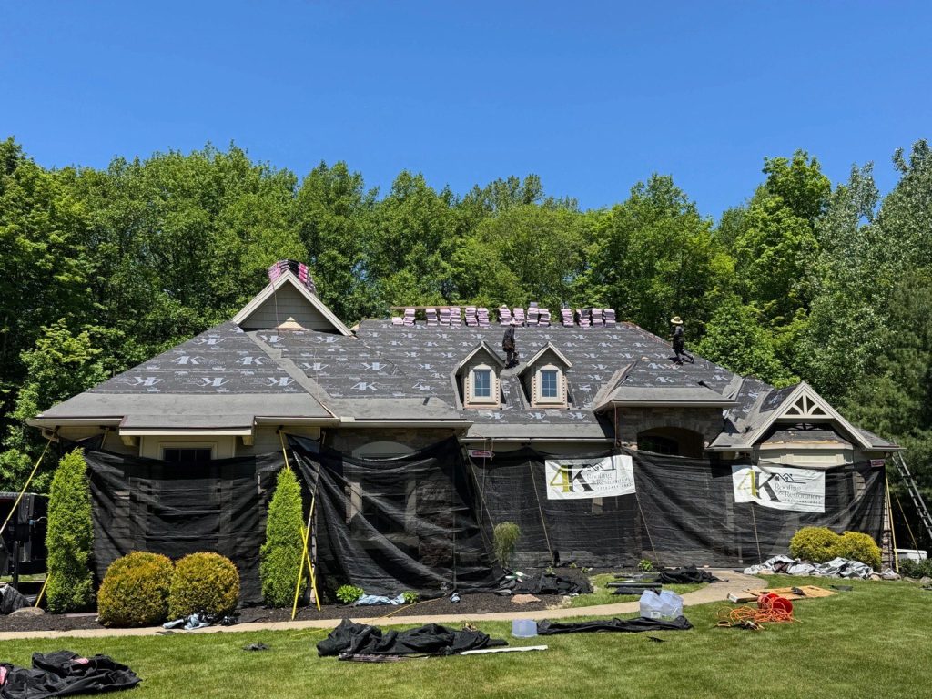 4K Roofing crew replacing a roof on a large Northeast Ohio home during an insurance claim