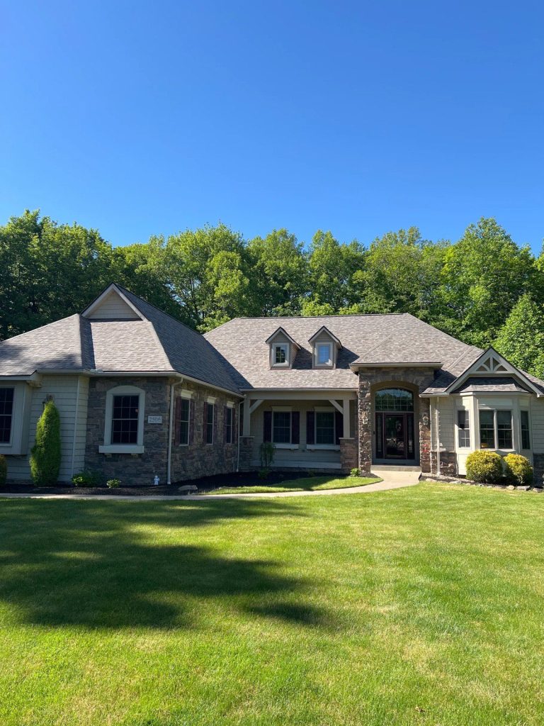 Finished roof replacement on a stone-and-siding Ohio home after an insurance claim