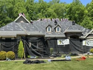 Roof replacement in progress on a large home in Hinckley, Ohio by 4K Roofing and Restoration